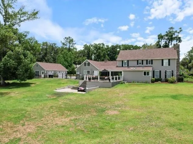 a aerial view of a house with swimming pool and garden