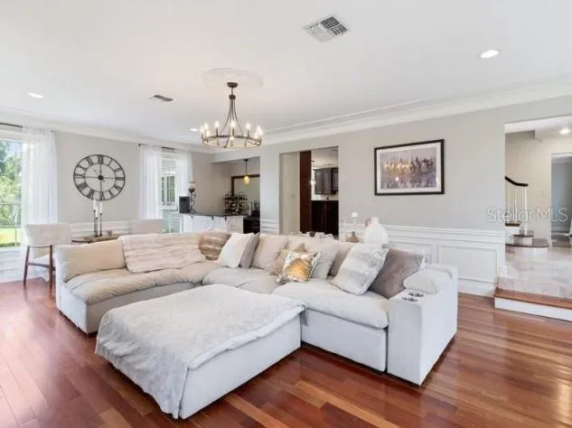 a living room with furniture and a chandelier