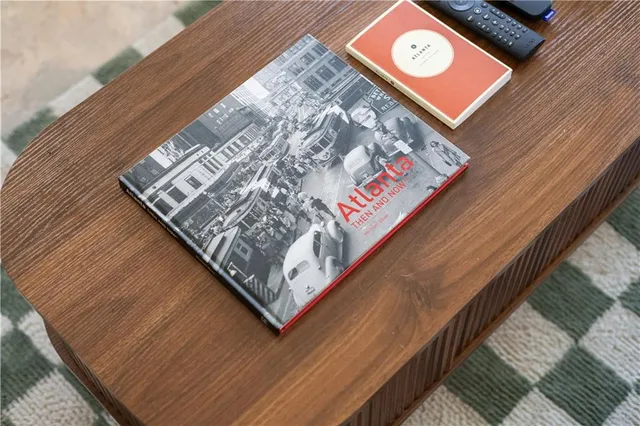 a view of a wooden house with a large window and wooden fence