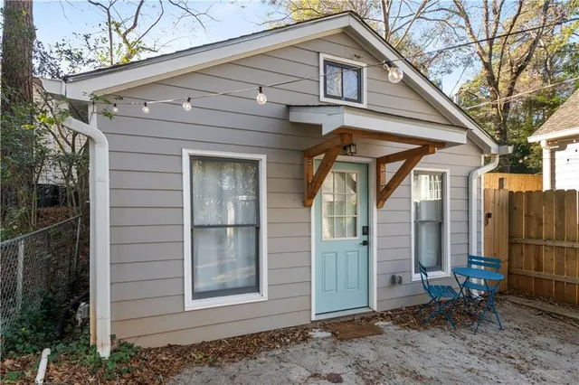 a living room with furniture and a lamp