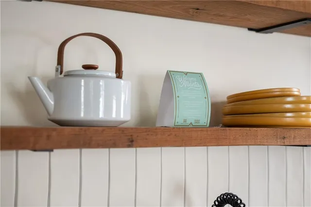 a kitchen with stainless steel appliances granite countertop a sink a stove and a wooden floors