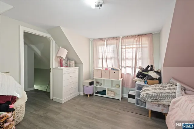 a bedroom with bed and a window