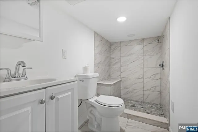 a bathroom with a toilet a sink and shower