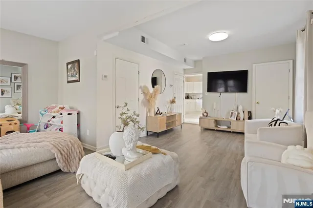 a bedroom with furniture and a flat screen tv