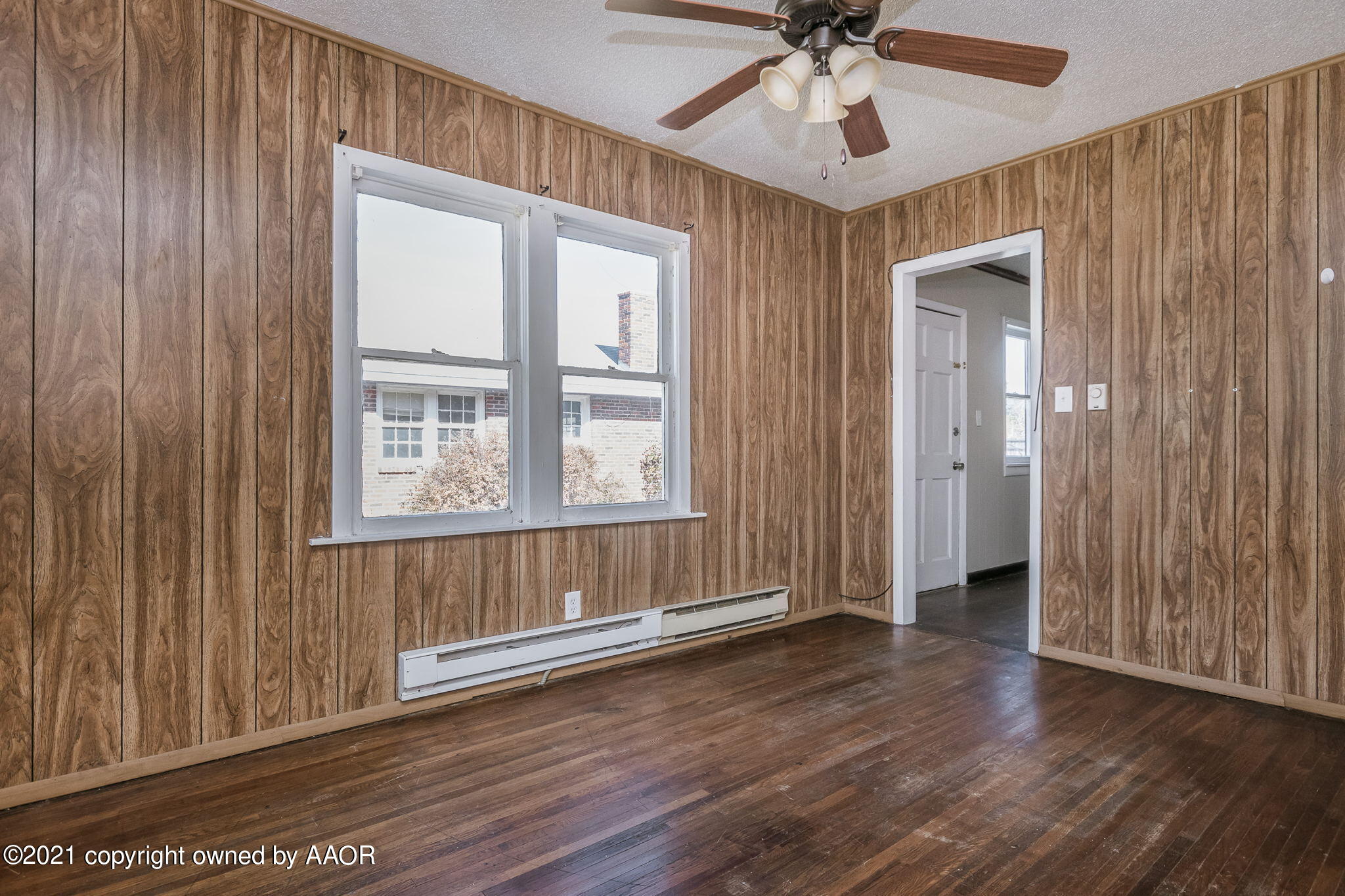 1104 South Western Street Amarillo, TX 79106 - Photo 11 of 29 an empty room with wooden floor fan and windows
