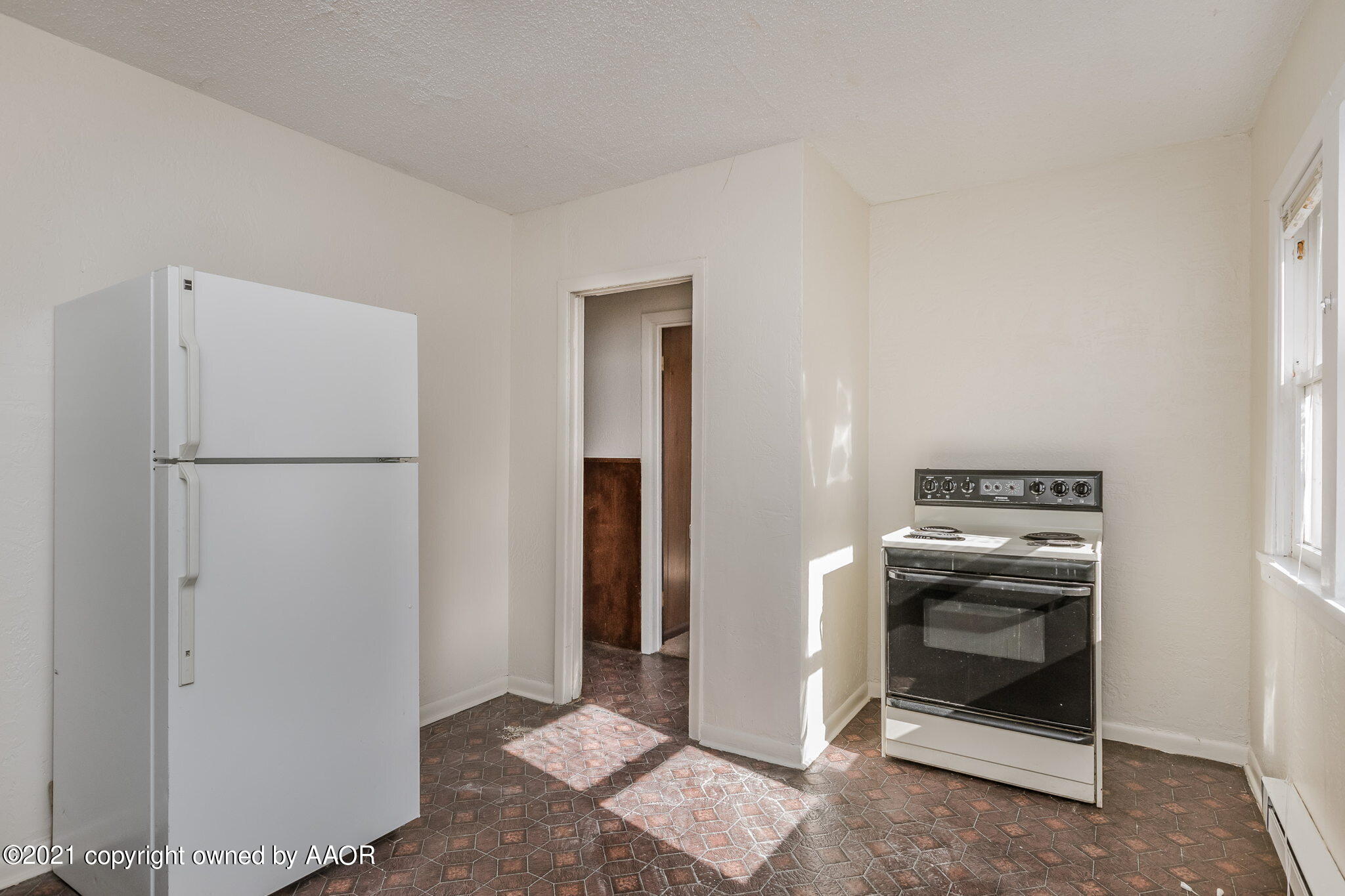 1104 South Western Street Amarillo, TX 79106 - Photo 20 of 29 a kitchen with a refrigerator and a stove