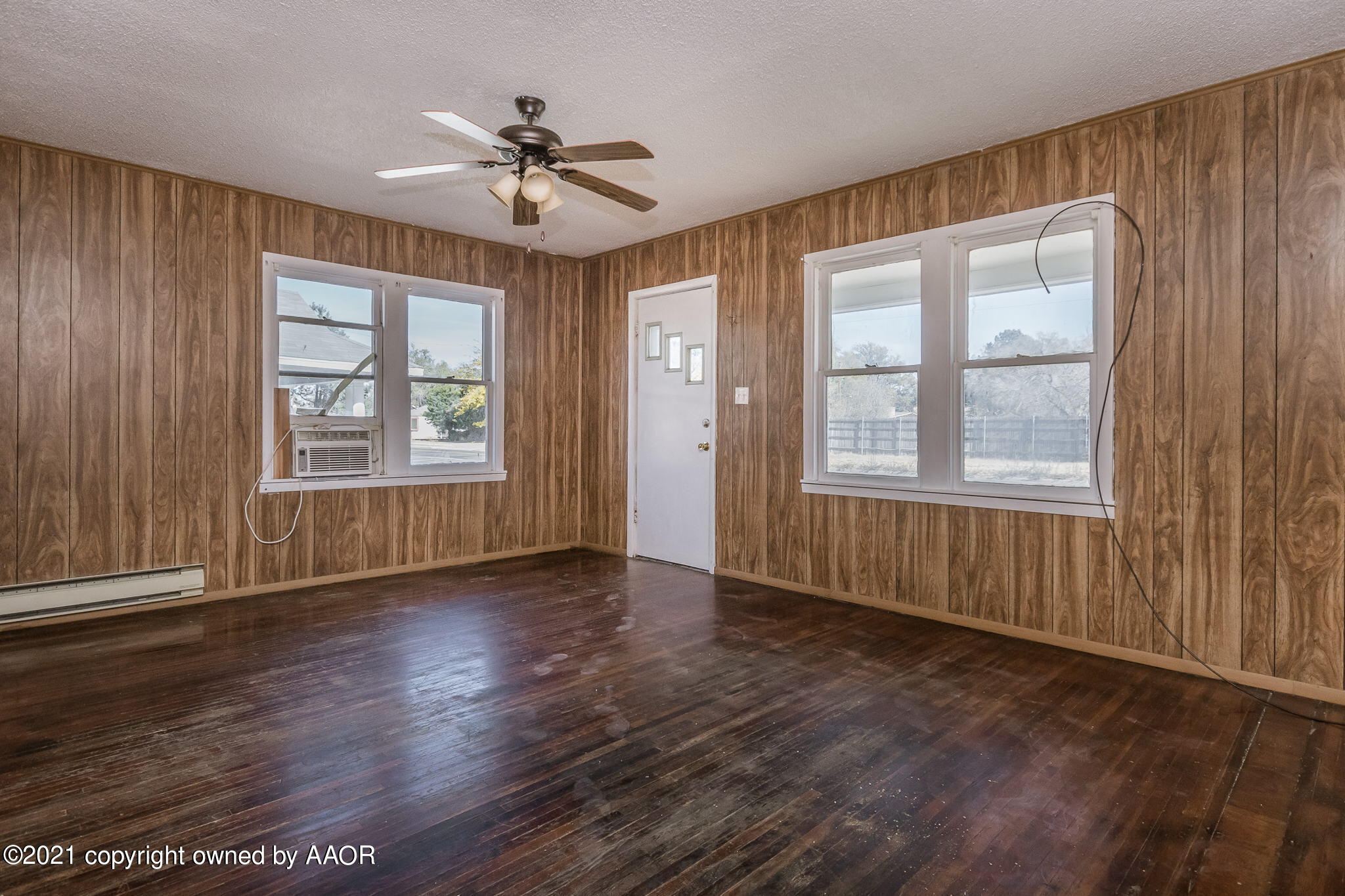 1104 South Western Street Amarillo, TX 79106 - Photo 3 of 29 a view of an empty room with a window and wooden floor
