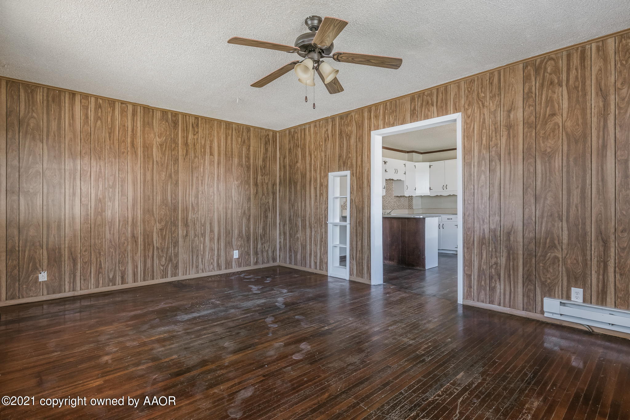 1104 South Western Street Amarillo, TX 79106 - Photo 4 of 29 a view of a livingroom with a chandelier fan front door and wooden floor