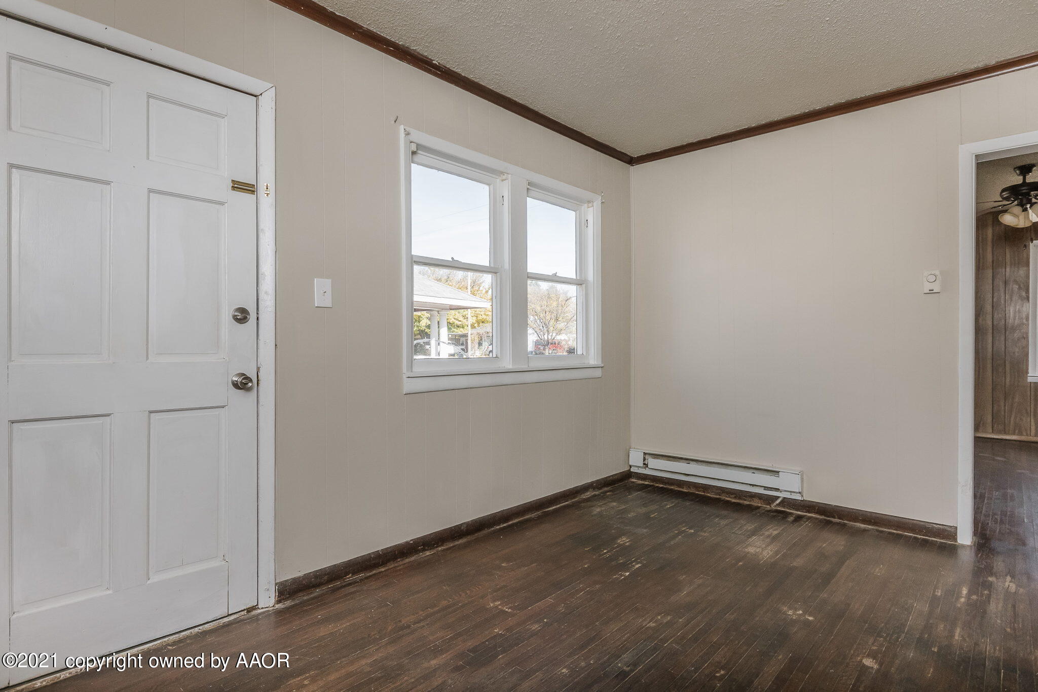 1104 South Western Street Amarillo, TX 79106 - Photo 5 of 29 a view of an empty room with wooden floor and a window