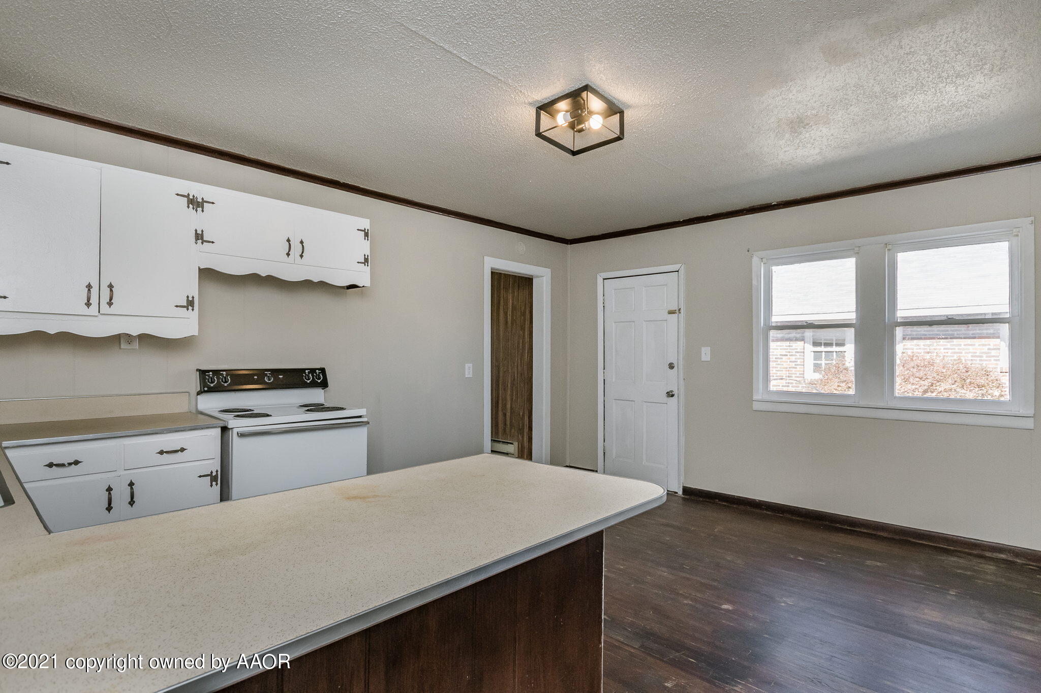 1104 South Western Street Amarillo, TX 79106 - Photo 8 of 29 a kitchen that has a lot of cabinets and wooden floor
