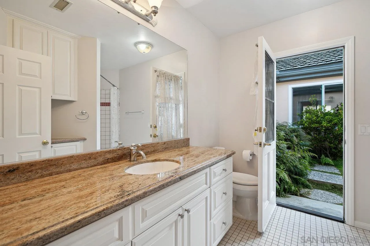 1532 Rancho Encinitas Drive Encinitas, CA 92024 - Photo 47 of 74 a bathroom with a granite countertop sink and a mirror