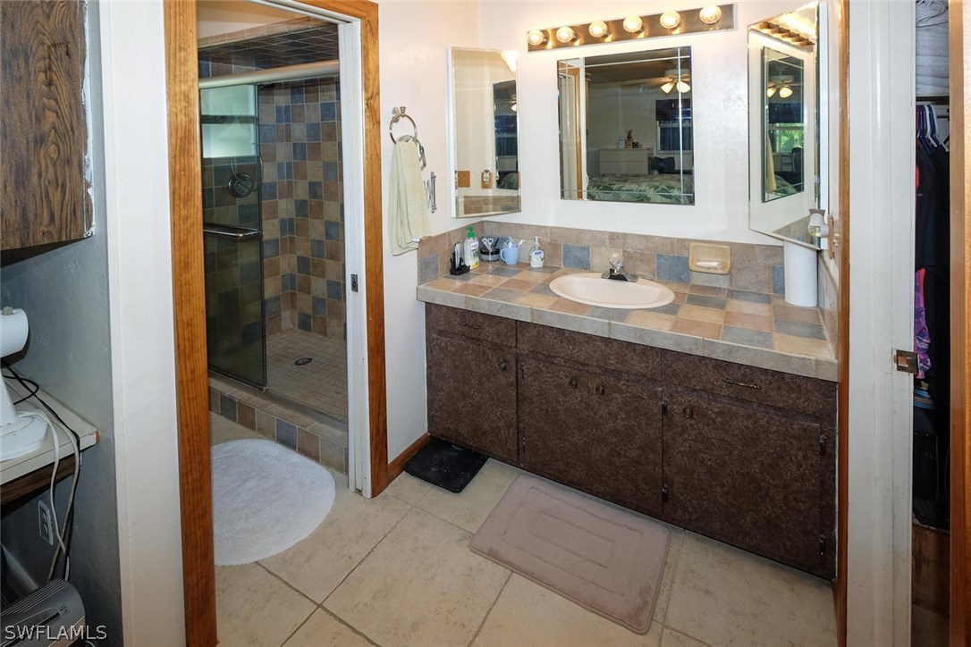 18554 Tulip Road Fort Myers, FL 33967 - Photo 15 of 25 a bathroom with a sink and a mirror