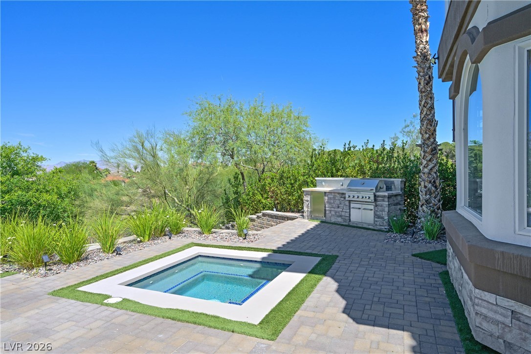 6 Rue Du Ville Henderson, NV 89011 - Photo 71 of 99 This private outdoor space features a tranquil spa and a built-in barbecue area, perfect for entertaining.