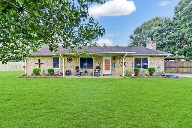 a front view of a house with a garden and porch