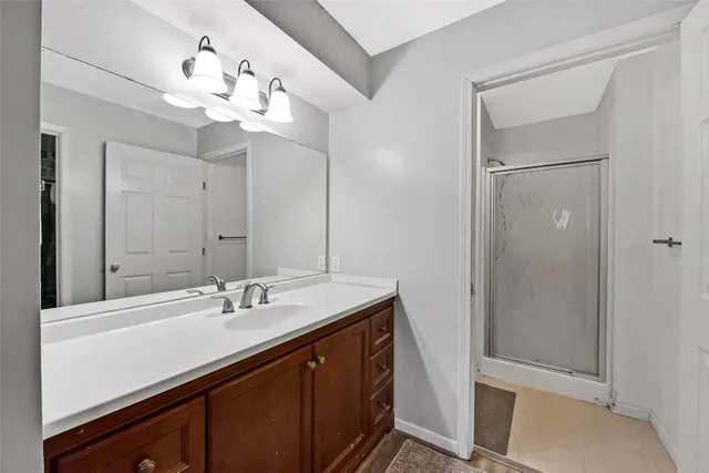 a bathroom with a sink a light fixture and a mirror