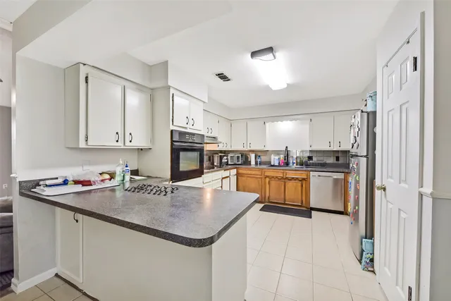 a kitchen with a sink a stove and cabinets