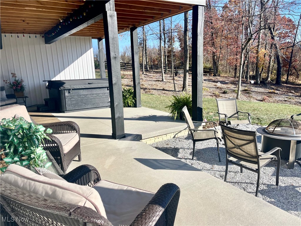 37250 Harry's Ridge Road Barnesville, OH 43713 - Photo 48 of 50 View of lower patio set up for a hot tub and an outdoor living space with a fire pit