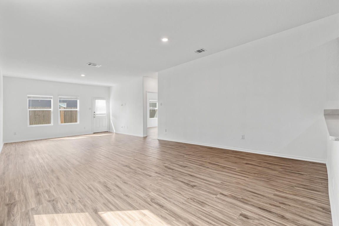 348 Soapstone Pass Maxwell, TX 78656 - Photo 15 of 18 a view of empty room with wooden floor and windows