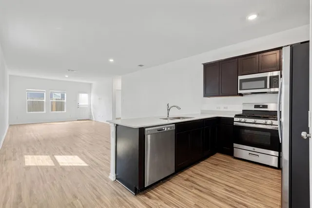 a kitchen with stainless steel appliances granite countertop a stove and a sink