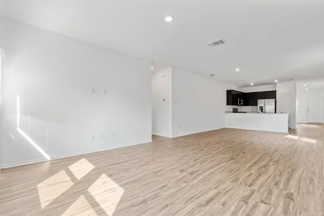 a view of kitchen with a sink and a refrigerator