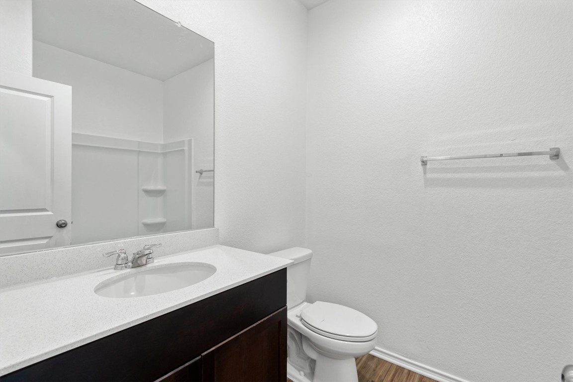 348 Soapstone Pass Maxwell, TX 78656 - Photo 8 of 18 a bathroom with a sink a toilet and a mirror