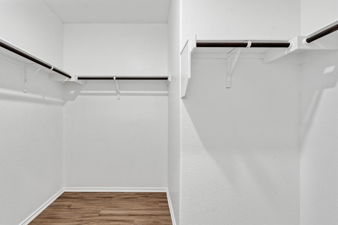 348 Soapstone Pass Maxwell, TX 78656 - Photo 10 of 18 a view of walk in closet with wooden floor