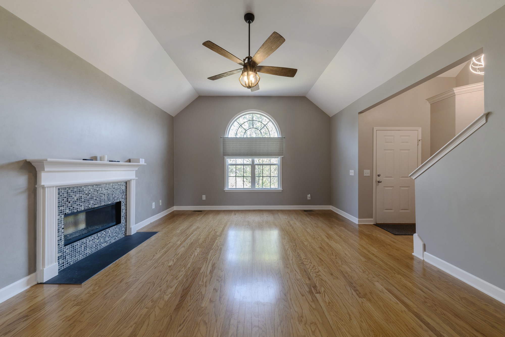 631 Harkreader Road Mount Juliet, TN 37122 - Photo 3 of 30 a view of an empty room with wooden floor fireplace and a window