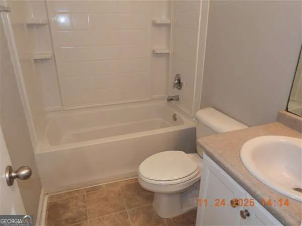 a bathroom with a toilet and a bathtub
