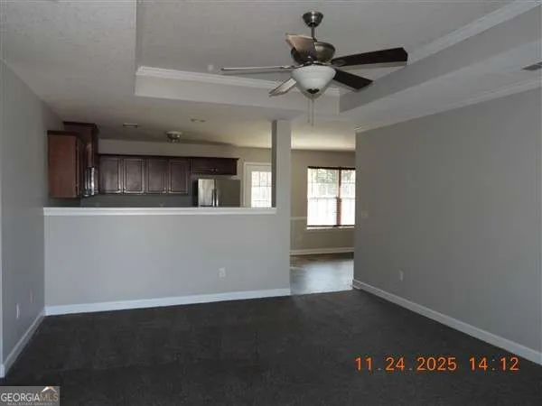 a view of a livingroom with a kitchen