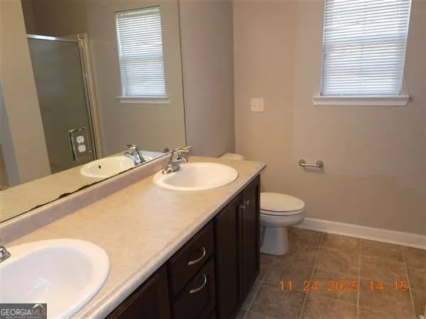a bathroom with a sink toilet and window