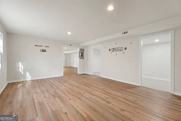 a view of empty room with wooden floor