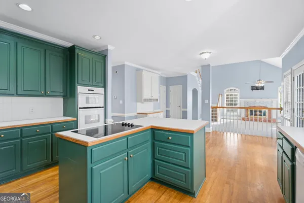 a kitchen with a sink cabinets and wooden floor