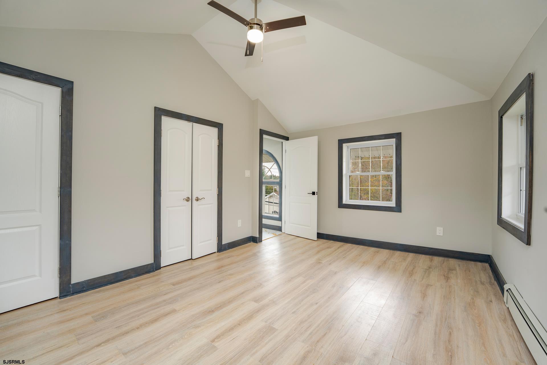 1203 West Mill Road Northfield, NJ 08225 - Photo 26 of 90 an empty room with wooden floor and windows