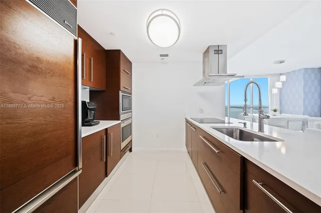 a kitchen with sink a stove and cabinets