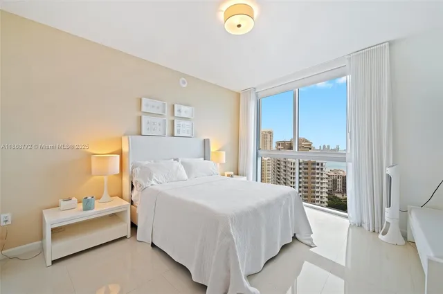 a bedroom with a bed and a large window