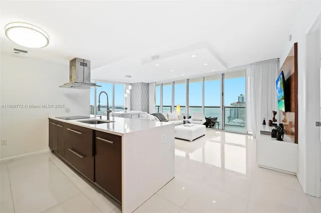 a kitchen with sink and white cabinets