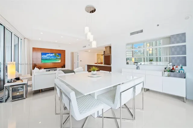 a large kitchen with a table and chairs