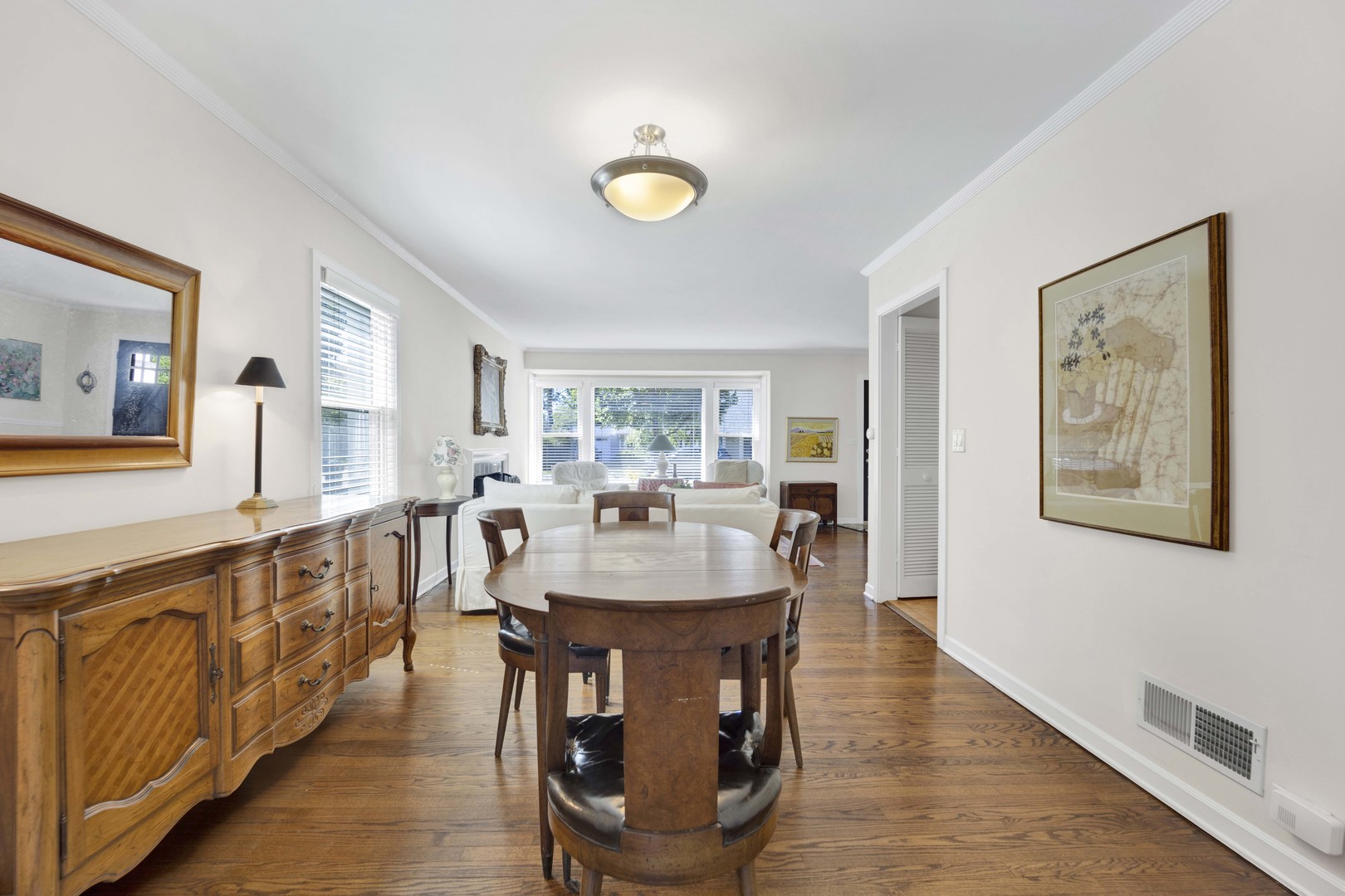 80 Williamsburg Road Evanston, IL 60203 - Photo 6 of 28 a dining room with wooden floor and entrance to ceiling windows