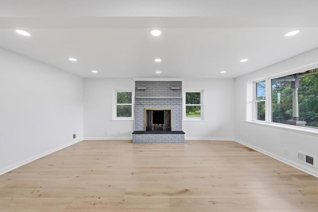 2412 Clearview Road Coplay, PA 18037 - Photo 8 of 53 Refined wood flooring and a classic brick fireplace anchor this bright, open living space.