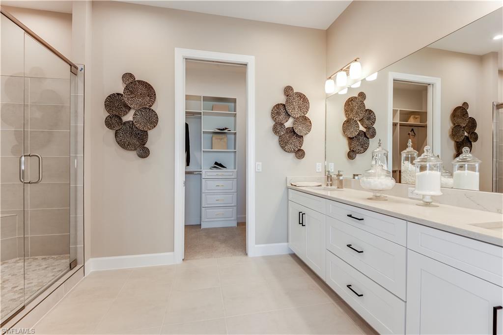 15336 Lucerna Street, Unit 203 Naples, FL 34114 - Photo 9 of 15 a bathroom with a sink and mirror