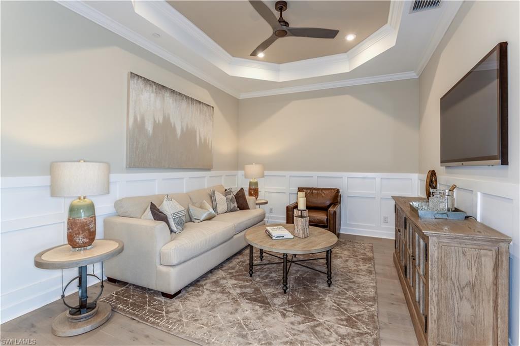 15336 Lucerna Street, Unit 203 Naples, FL 34114 - Photo 8 of 15 a living room with furniture and a flat screen tv