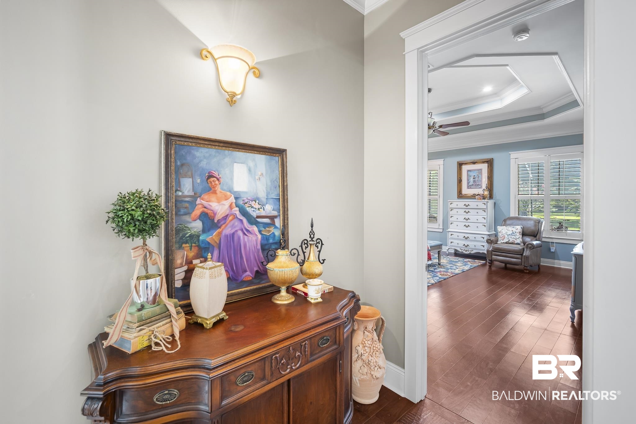 25212 Austin Road Daphne, AL 36526 - Photo 19 of 56 Hall featuring a raised ceiling, crown molding, and dark wood-type flooring