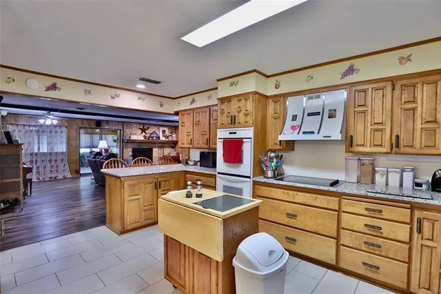 a kitchen with granite countertop a stove and cabinets