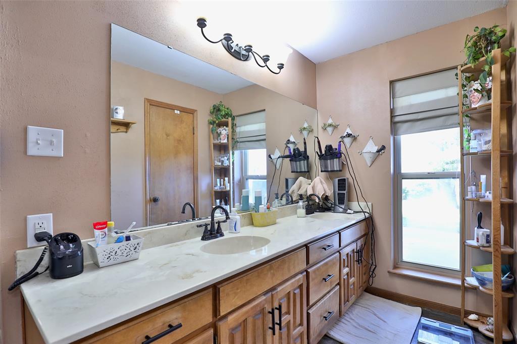 448 Elmdale Road South Abilene, TX 79602 - Photo 16 of 39 a bathroom with a sink double vanity and a mirror