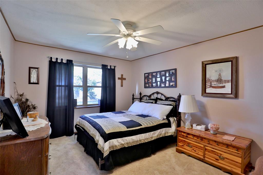 448 Elmdale Road South Abilene, TX 79602 - Photo 18 of 39 a bedroom with a bed and a chandelier
