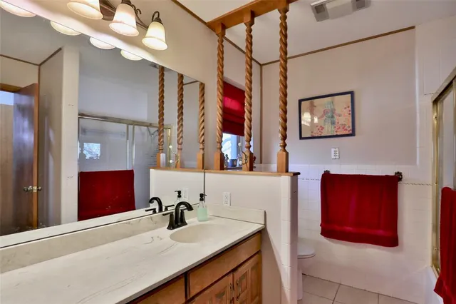 a bathroom with a sink vanity and a mirror
