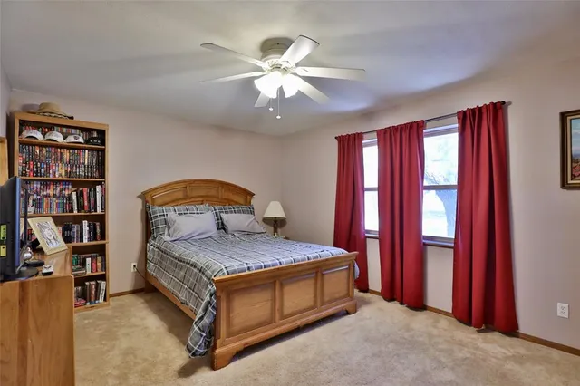 a spacious bedroom with a bed and window