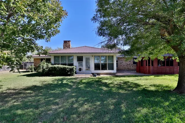 a front view of a house with swimming pool having outdoor seating