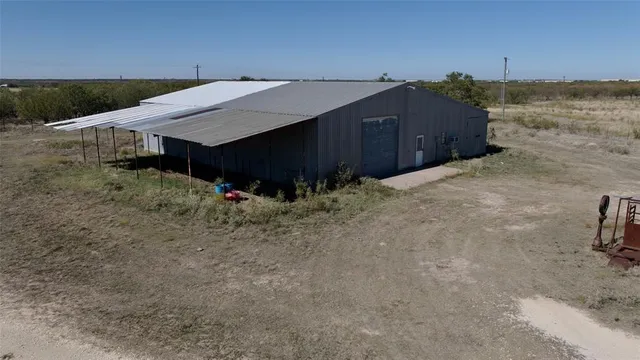 a view of a house with wooden fence