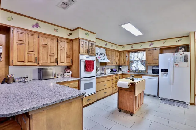 a kitchen with granite countertop cabinets and stainless steel appliances